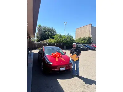 Manic Motors customers with their newly purchased cars